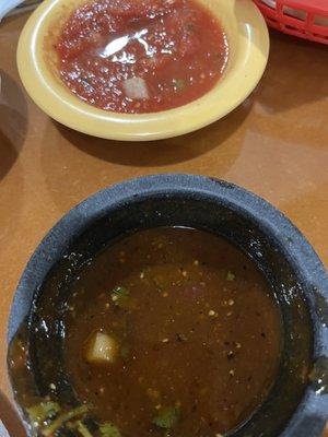 Mild is the bright red salsa and hot is the darker