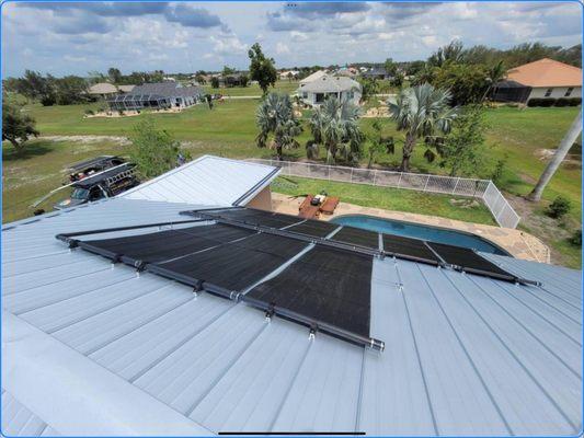 Aquatherm solar pool heating system with specialized attachments for a standing seam metal roof.