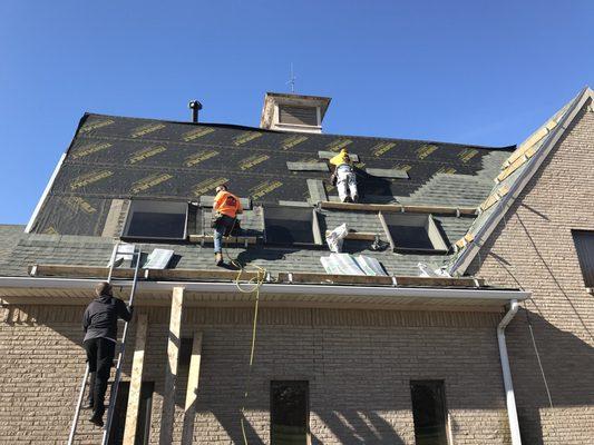 Replacing shingles on barn.