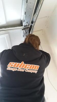 One of our repair technicians finishing up a repair on a garage door.