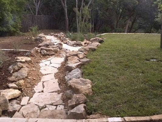 Dry creek bed to address sever site drainage