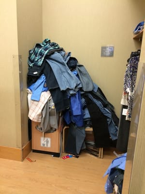 Pile of clothes in the dressing room at least 6 ft high.