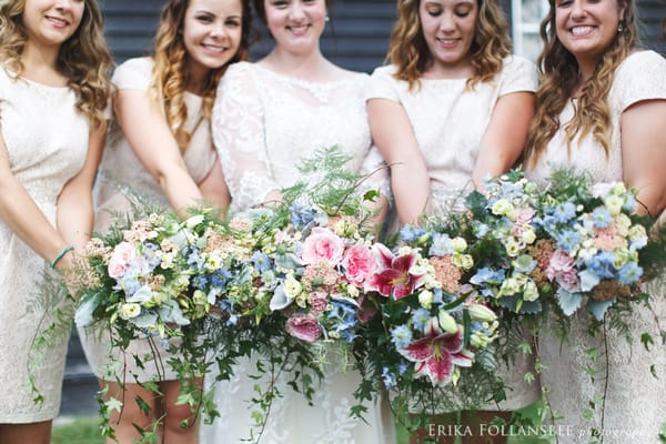 Smiling bridesmaids with beautiful bouquets | photo by Erika Follansbee