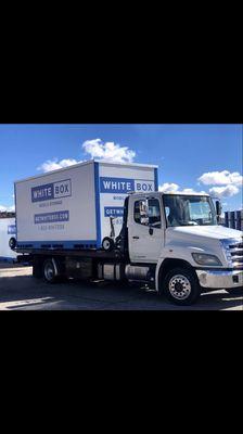 White Box Mobile Storage truck with portable storage unit atop.