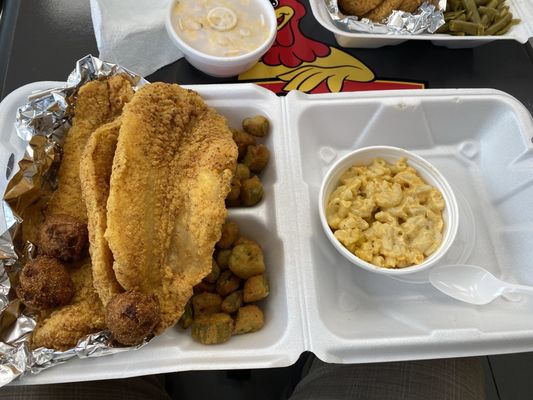 Catfish dinner with fried okra and Mac and cheese and hush puppies.