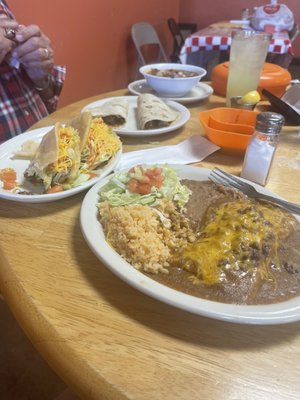 Menudo, homemade tortillas, carne guisada tacos, puffy beef tacos, beef enchilada, beef tamale, beans and rice.