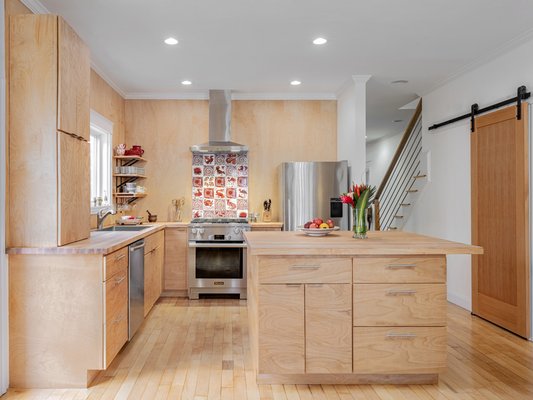 Kitchen as an extension of the dining room cabinetry without the utilitarian style of typical kitchen