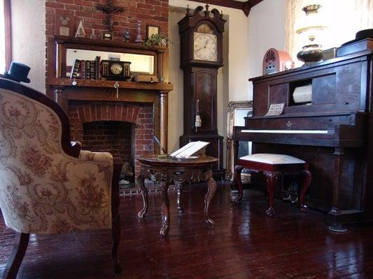 The Drawing room, offering a gas fireplace and a 1921 player piano.  Excellent for relaxing with a cup of hot tea and a good book.