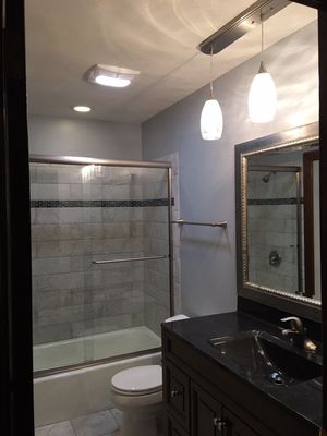 This remodel includes an Onyx Collection vanity top and new tile on the shower walls.