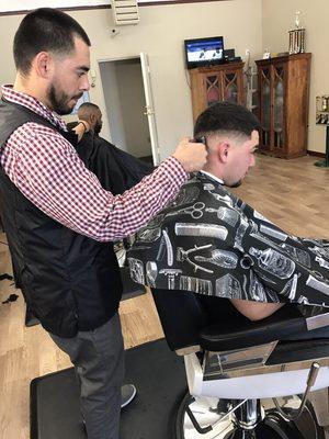 Daniel Focused and Executing a Low Razor Fade.