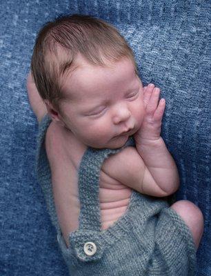 Newborn baby boy on blue