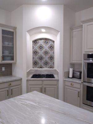 Quartz tops with cooktop and tile backsplash