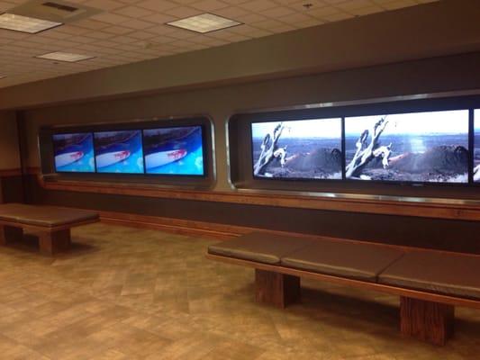 As you walk in past the reception area.  Wall of TVs.