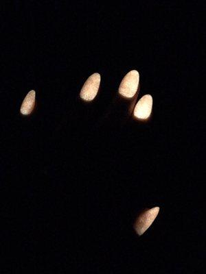 Glow in the dark Nexgen dip powder on almond shaped natural nails.