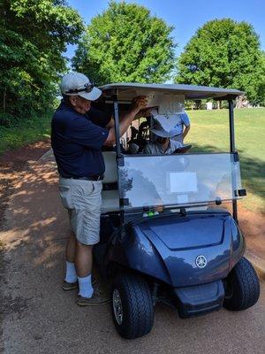 Starter inserting tee time sheets into our carts.