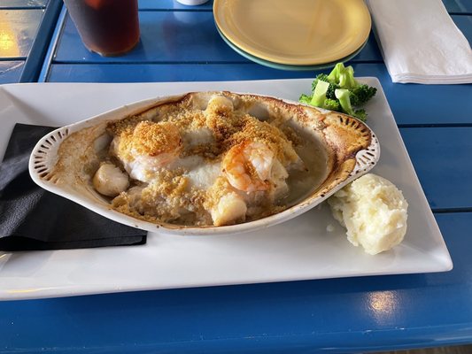 Broiled Seafood with mashed potatoes and broccoli side.