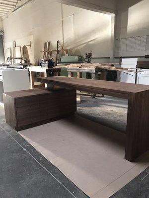 An executive desk with custom credenza made out of walnut oil rubbed to its natural beauty