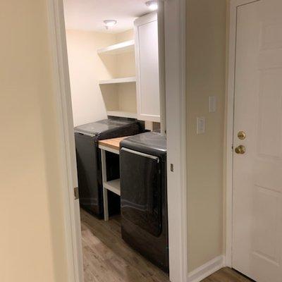 Was a plain closet, now custom condo laundry