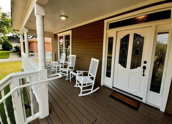 Front entrance, and front porch seating along Goliad Street.