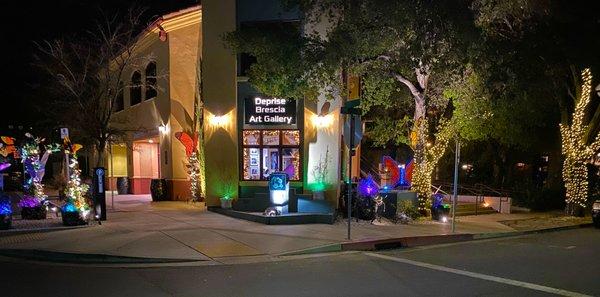 Deprise Brescia Art Gallery at night.  The Wings of Change Butterfly Sculpture Garden lights up the corner of 10th and Pine Street.