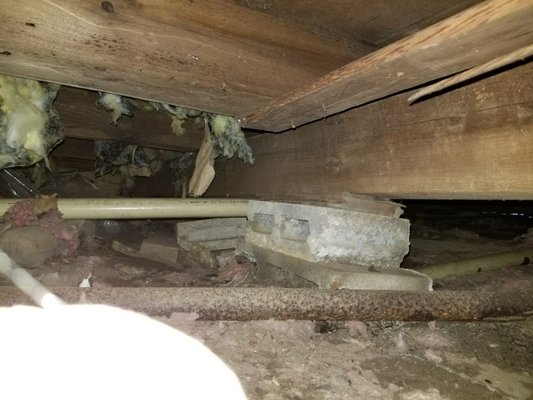 Failing supports in a crawlspace.