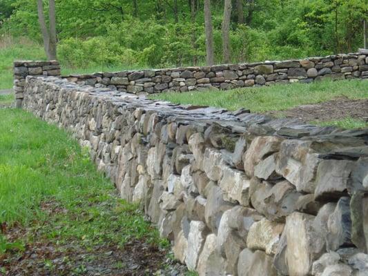 Stone wall Tuxedo NY.  Natural stone wall built parallel with a country road.