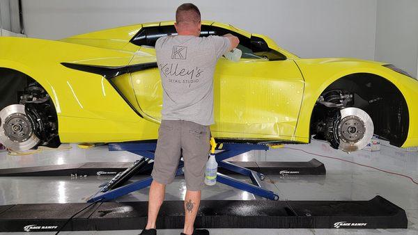 Installing matte PPF on the passenger door of an Accelerate Yellow Z06