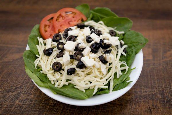 Spinach salad: Spinach, provolone cheese, black olives, tomatoes. feta cheese