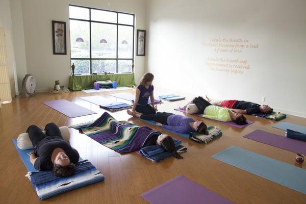 Resting in Savasana during Yoga class at Wellness 360