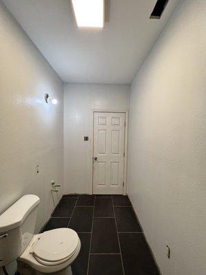 Restroom renovation that included drywall repair, texture and paint.