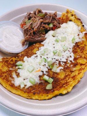 Cachapa (Venezuelan corn cake) with shredded beef and white cheese