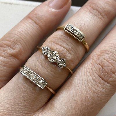 Antique Edwardian and Art Deco diamond "trilogy" rings, circa 1920. All 18k yellow gold with platinum tops.