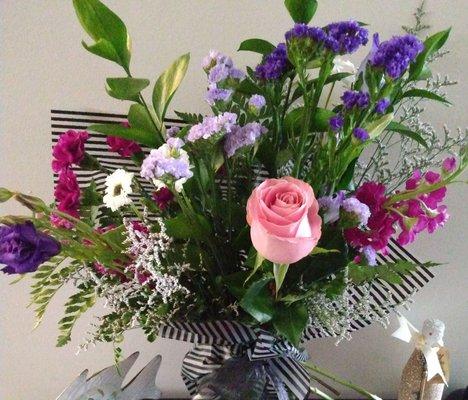 Another view of the arrangement with a pink rose