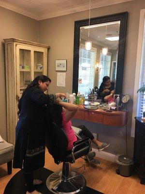 Owner doing eyebrow threading