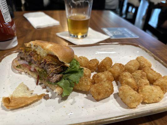 Partway through my Texas Tequila Bacon Cheddar Burger, tater tots, and beer.