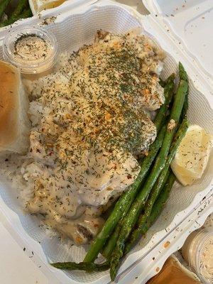 Smothered chicken over rice with asparagus