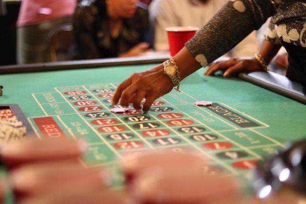 A close up view of our guests placing bets on our Roulette Table!