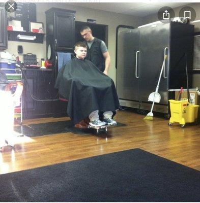 (Brian) cutting hair in 2015.