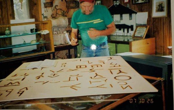 Volunteer Randy Gorsett putting finishing touches on the brand board.