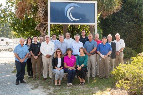 The Carolina Filters team with their logo sign