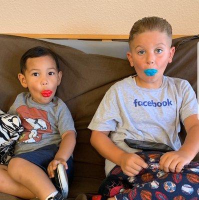 These two handsome little guys are enjoying there  lollipops