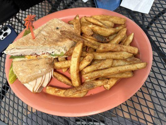 Turkey Pressed Sliced turkey with avocado, bacon, colby jack cheese and ranch dressing on a pressed ciabatta roll with fries.