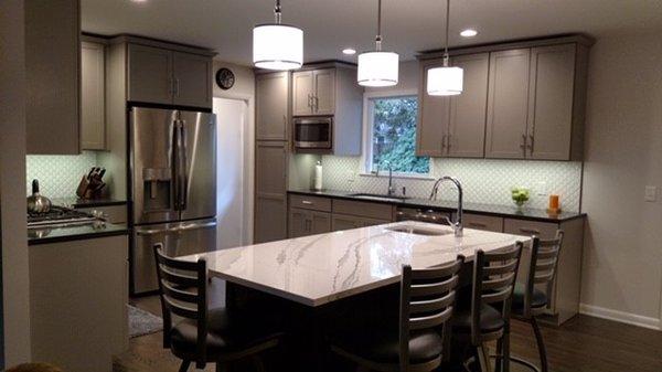 A Cambria quartz countertop and painted cabinets designed by a kitchen and bath designer at The Woodsmiths in Kalamazoo, MI.