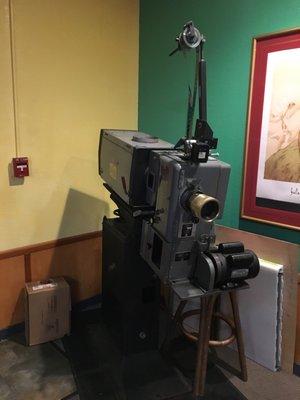 Old 35 mm projector on display in lobby.