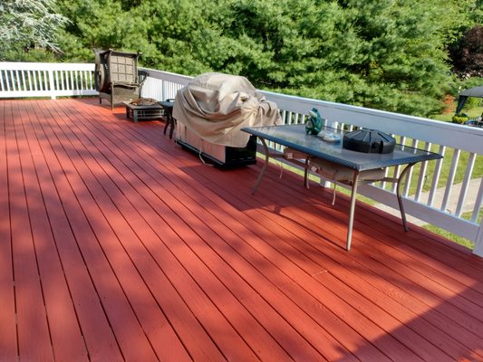 Solid color redwood stain with white railings