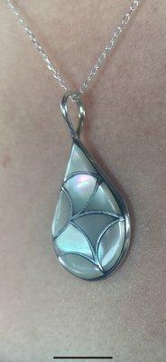 Mother of Pearl pendant with 16" sterling silver chain.