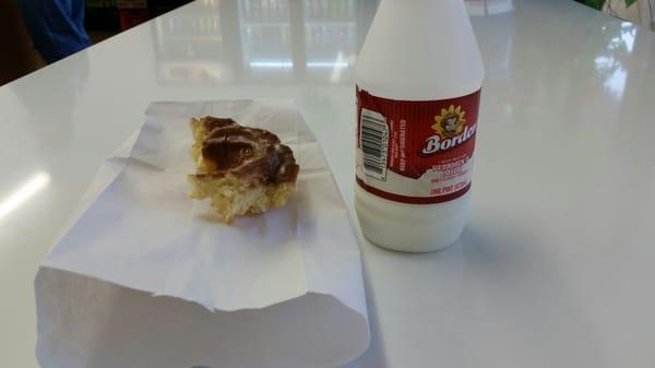 Breakfast on the go!  Old fashioned chocolate glazed donut and milk.