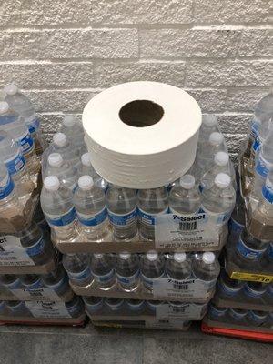 Exposed Toilet paper roll on top of bottled water to sell