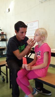 My daughter getting her face painted.  She looks thrilled, doesn't she?  :-D