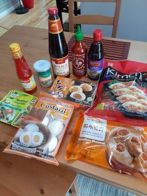 Assorted sauces, frozen dim sum, sour soup powder packet